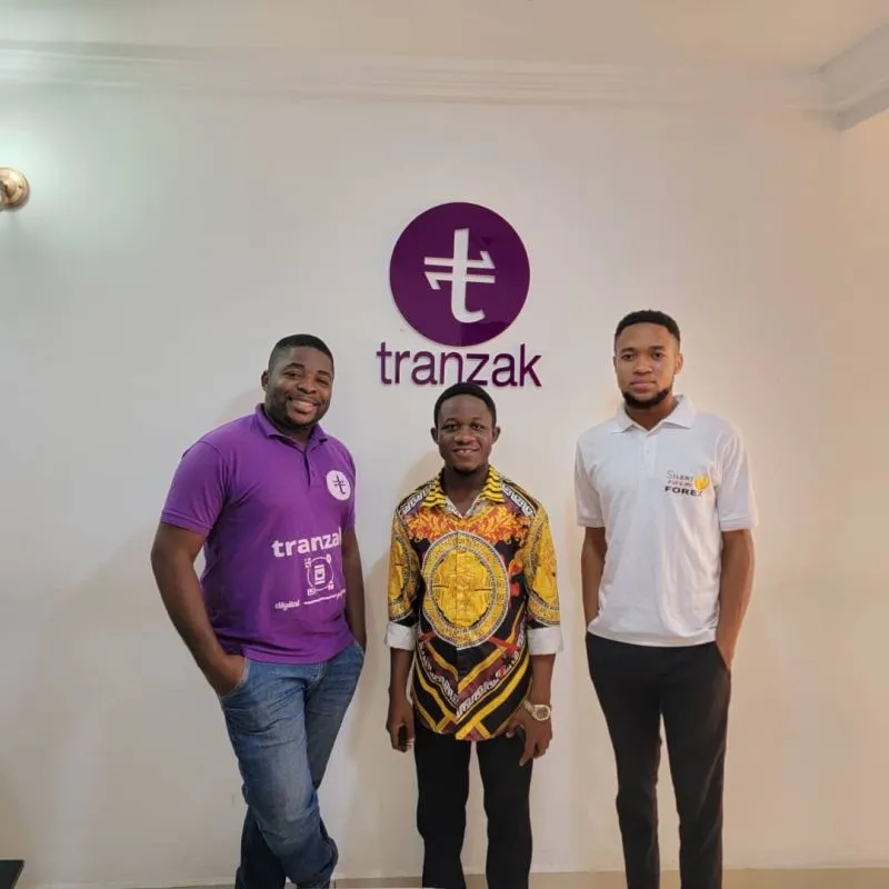 Skye8 visit to Tranzak, three men in front of the Tranzak logo